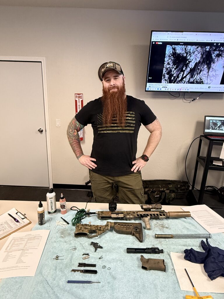 55th Light Foot member leading a firearm cleaning and maintenance training session focused on safety, preparedness, and responsible equipment care.