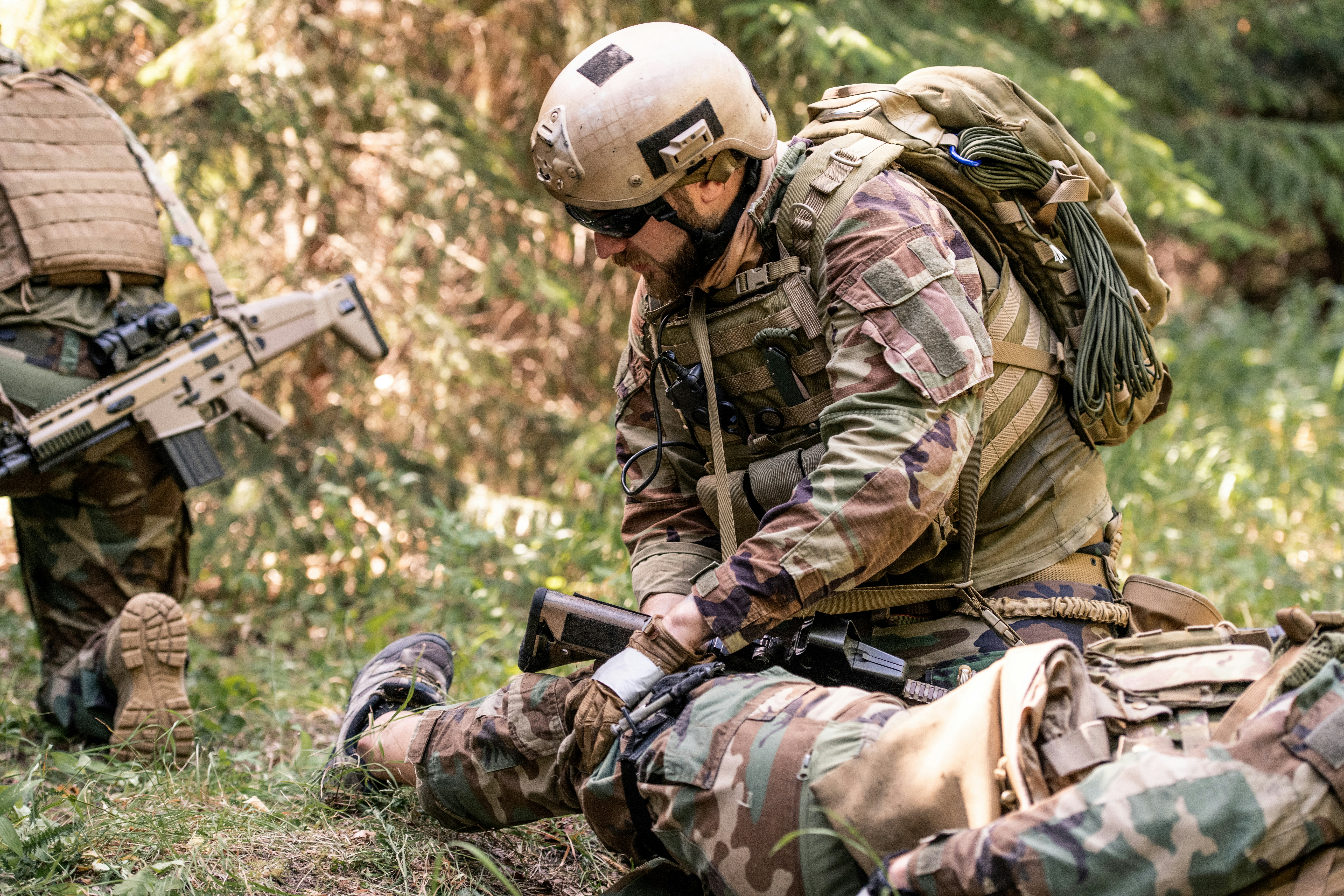 55th Light Foot Battalion members conducting emergency medical response and field casualty care training during outdoor preparedness exercise.